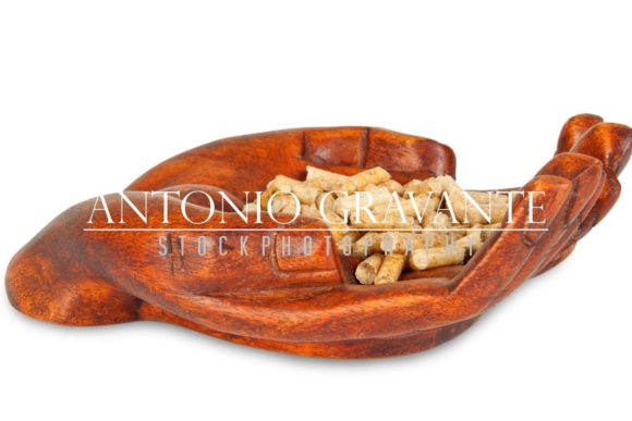 Wood Pellets in a Decorative Hand: A Versatile Visual Asset for Creative and Professional Use